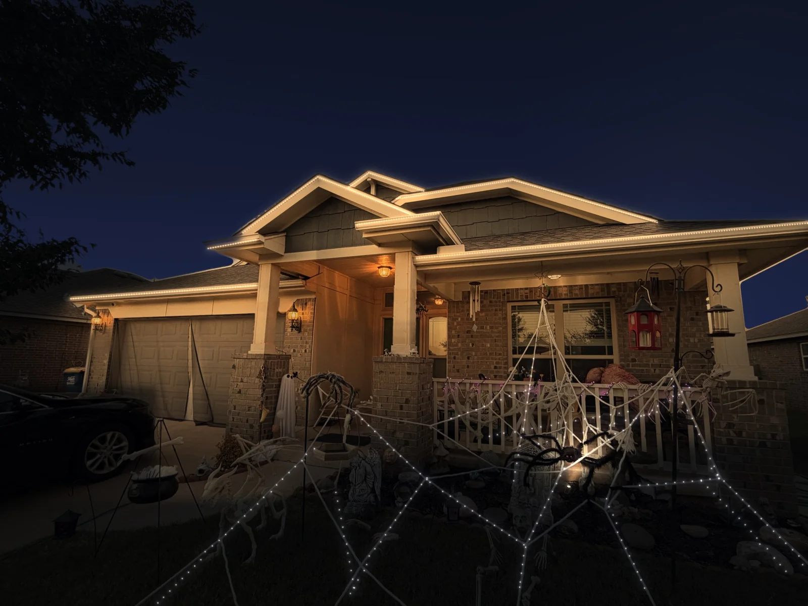 Mockup of a brick home at night with its roofline lit in warm white